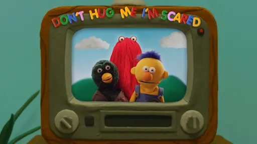 green duck puppet, red puppet, and yellow puppet within a tv screen with text on top 'don't hug me i'm scared'.